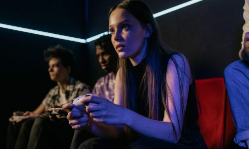Girl focuses while playing video games.